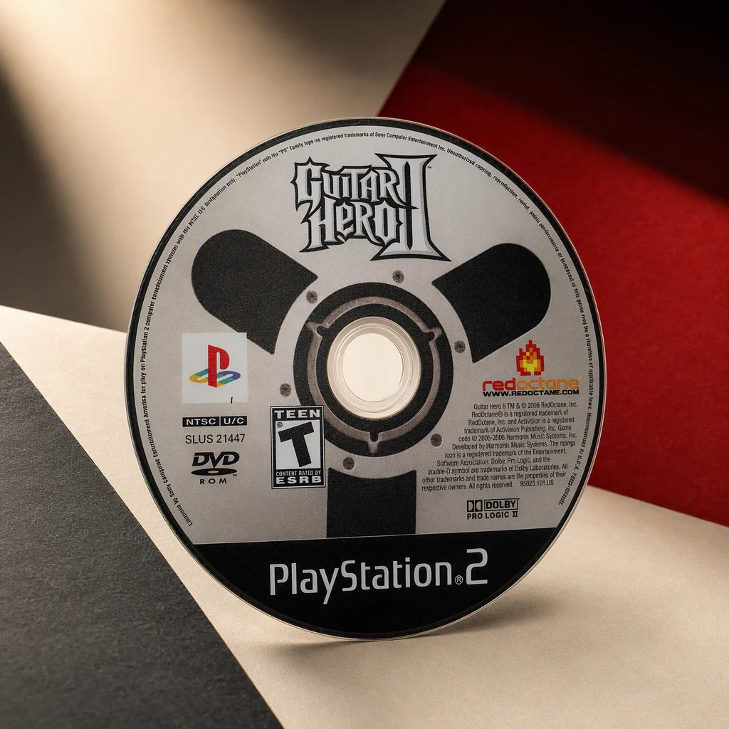 Representative Guitar Hero II one loose black-label North American PlayStation 2 DVD disc in a cream and charcoal editorial composition, not the specific RGM unit