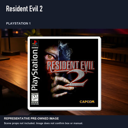 Representative pre-owned Resident Evil 2 (PlayStation 1), product image in a styled desk scene.