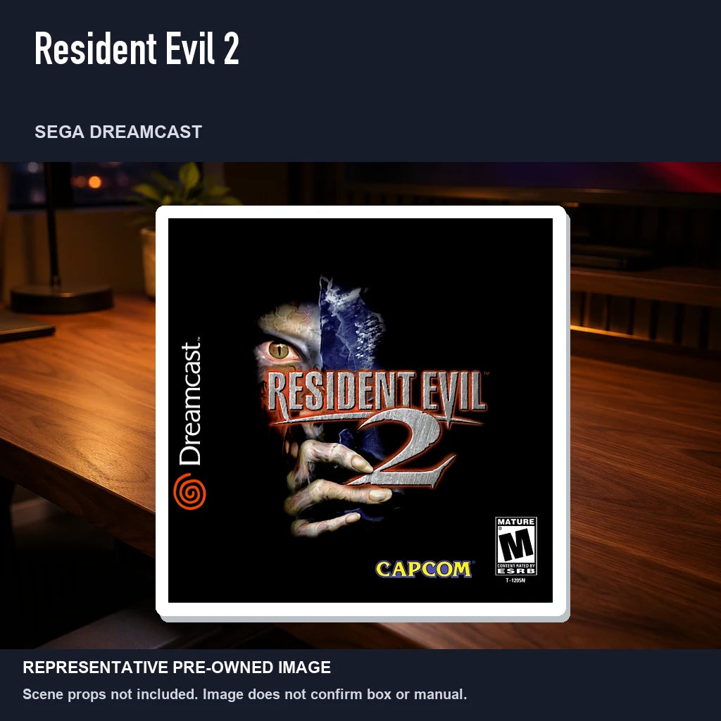Representative pre-owned Resident Evil 2 (Sega Dreamcast), product image in a styled desk scene.