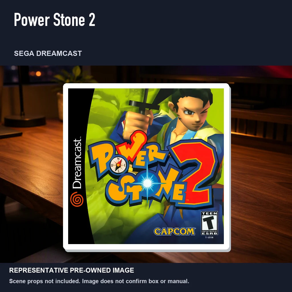 Representative pre-owned Power Stone 2 (Sega Dreamcast), product image in a styled desk scene.