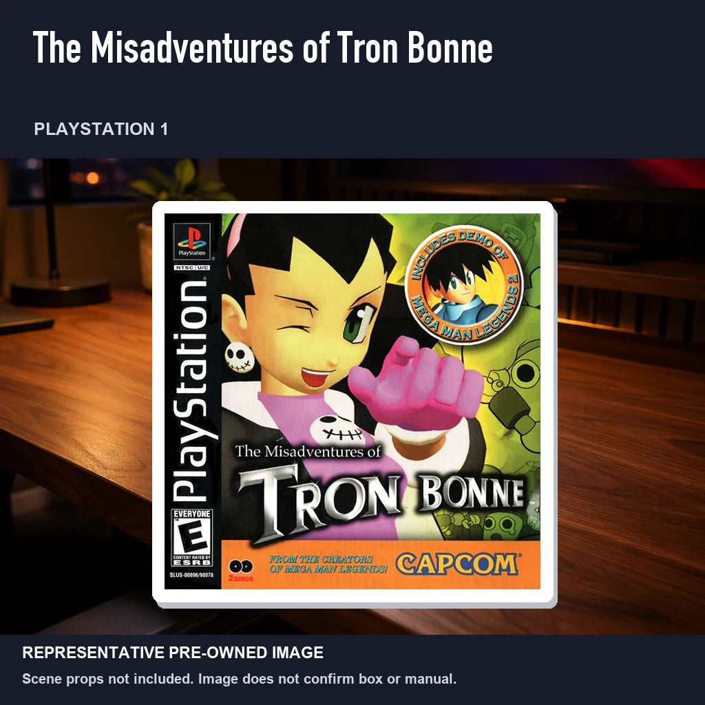 Representative pre-owned The Misadventures of Tron Bonne (PlayStation 1), product image in a styled desk scene.