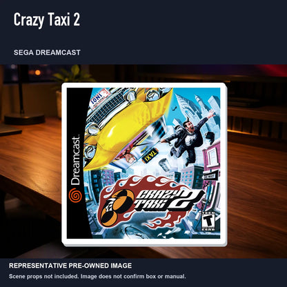 Representative pre-owned Crazy Taxi 2 (Sega Dreamcast), product image in a styled desk scene.
