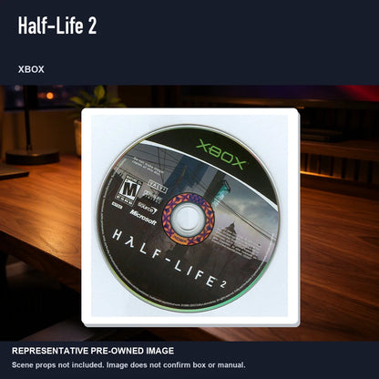 Representative pre-owned Half-Life 2 (Xbox), product image in a styled desk scene.