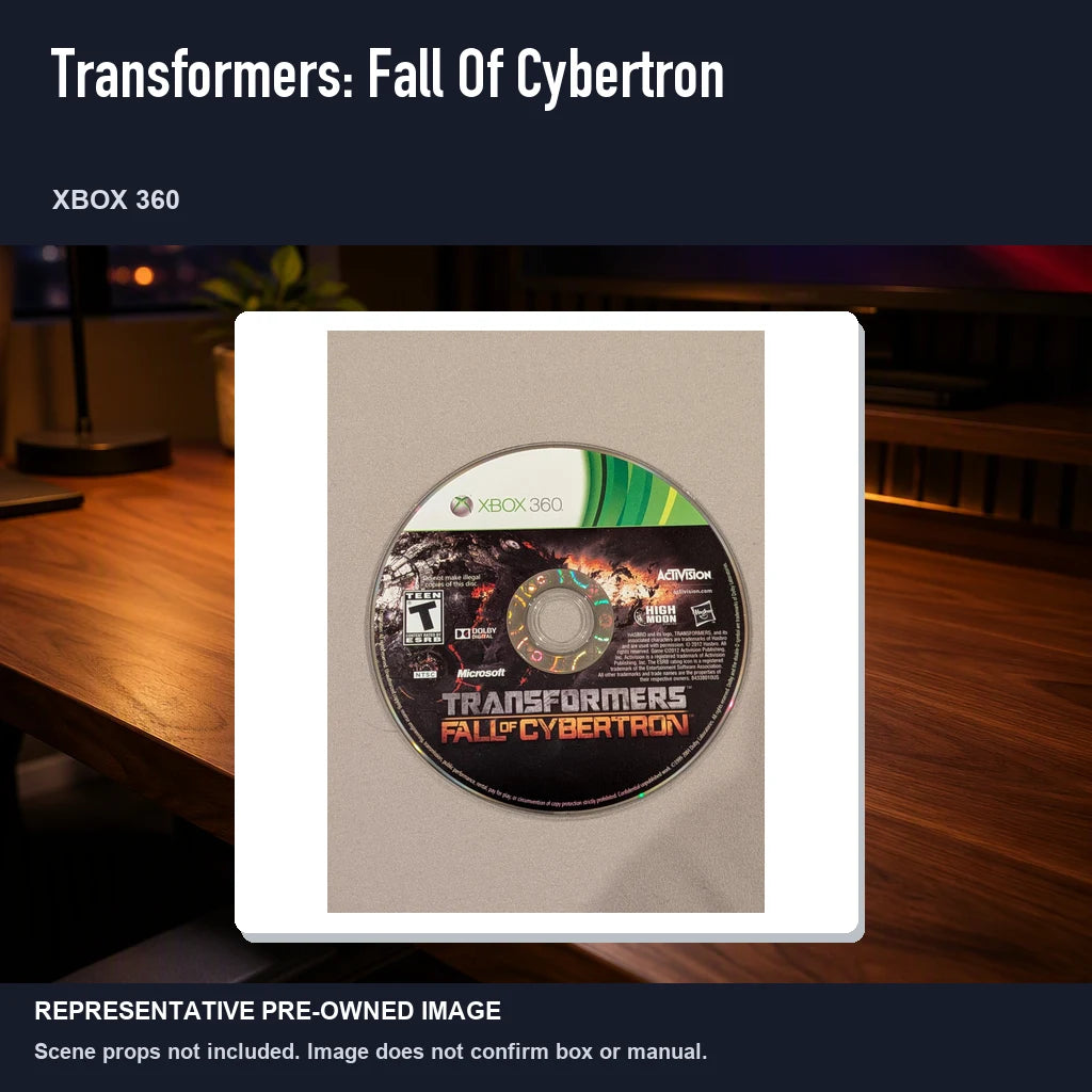 Representative pre-owned Transformers: Fall Of Cybertron (Xbox 360), product image in a styled desk scene.