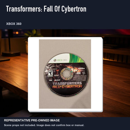 Representative pre-owned Transformers: Fall Of Cybertron (Xbox 360), product image in a styled desk scene.