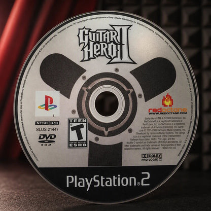 Representative Guitar Hero II one loose black-label North American PlayStation 2 DVD disc in a close macro view of the authentic printed identity, not the specific RGM unit