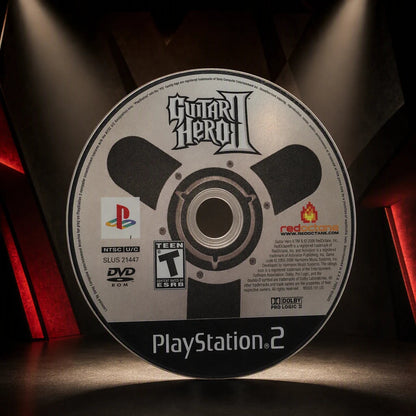 Representative Guitar Hero II one loose black-label North American PlayStation 2 DVD disc displayed alone in a dark museum alcove, not the specific RGM unit