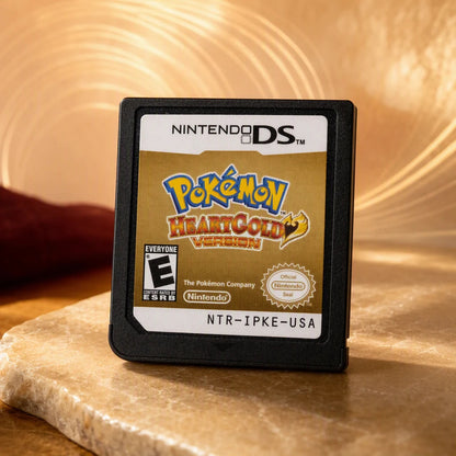 Representative Pokemon HeartGold Version one loose black North American Nintendo DS cartridge on a warm editorial tabletop with shallow depth of field, not the specific RGM unit